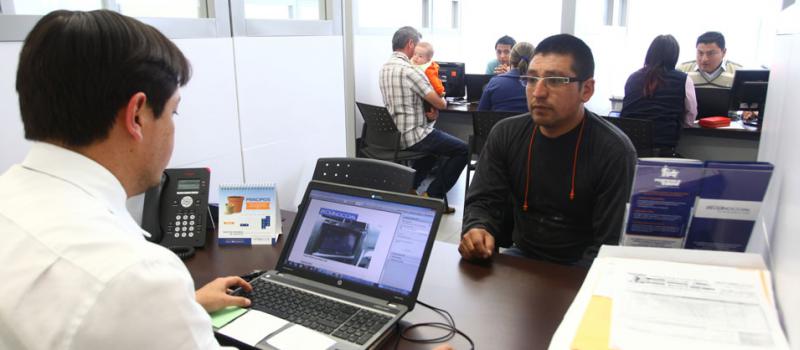 Un empleado de Seguros Equinoccial atiende a un cliente en las oficinas de la compañía, en el norte de Quito. La empresa es parte de las 35 aseguradoras que operan en el país. Foto: Julio Estrella / LÍDERES.