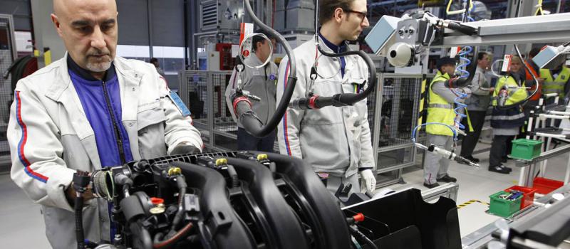 Empleados del fabricante de automóviles francés PSA Peugeot Citroen trabajan en la nueva línea de montaje de motores “EB”, en la fábrica de motores de la firma en Tremery (Francia). Foto: Vincent Kessler / Reuters